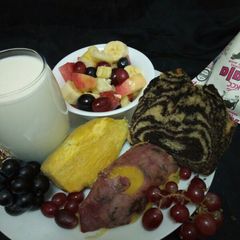 A picture of Fruit salad, zebra cake, sweet potatoe and fermented milk(mala).