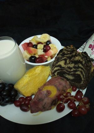 A picture of Fruit salad, zebra cake, sweet potatoe and fermented milk(mala).