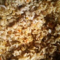 A picture of Jollof rice and pomo.