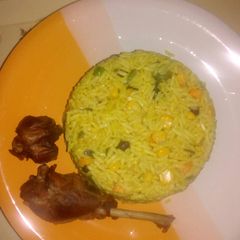 A picture of Fried rice with fried chicken.