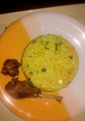A picture of Fried rice with fried chicken.