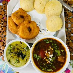 A picture of Idli Meduvada Sambhar with green chatani.