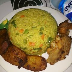 A picture of Fried Rice, Fried Plantain with Grilled Turkey.