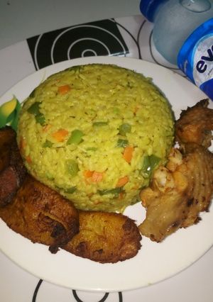 A picture of Fried Rice, Fried Plantain with Grilled Turkey.