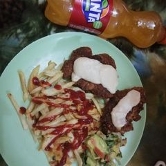 A picture of Fries and chicken gaucamole and gravy.
