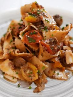 Una foto de Tallarines picantes con cherrys y pesto de nueces