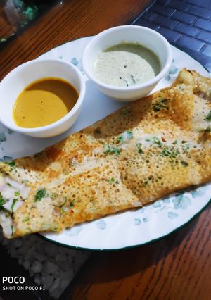 A picture of Onion Rava dosa with chutney.
