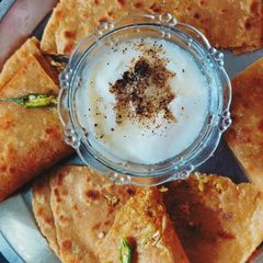 A picture of Gobhi paratha with mitha Dahi.