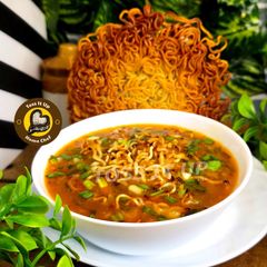 A picture of Indo Chinese Restaurant Style Veg Hot And Sour Soup With Fried Noodles.