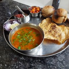 A picture of Rajasthani dal bati with instant raw mango pickle.