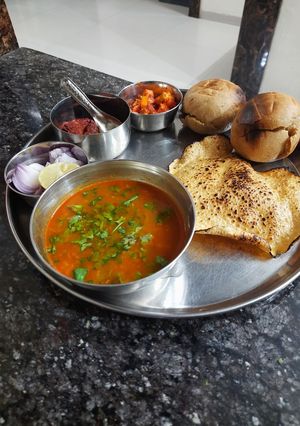 A picture of Rajasthani dal bati with instant raw mango pickle.