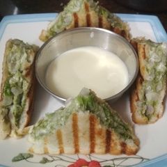 A picture of Mayo sandwich with cheese dip.