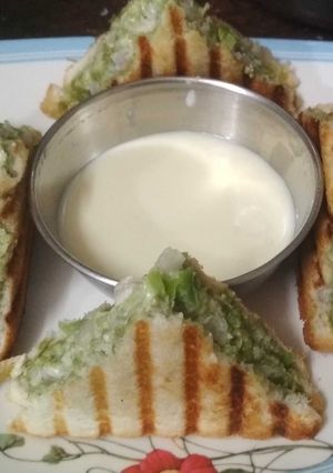 A picture of Mayo sandwich with cheese dip.