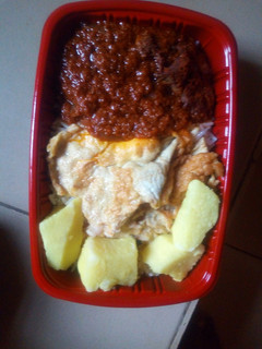 A picture of Boiled yam with fried egg and sauce.