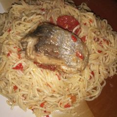 A picture of Jollof spaghetti and cooked fish.