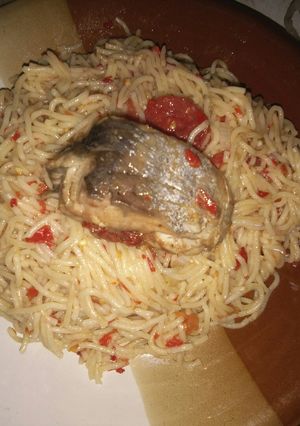 A picture of Jollof spaghetti and cooked fish.