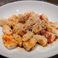 A picture of Homemade Ricotta Gnocchi With Cherry Tomatoes and Basil sauce.