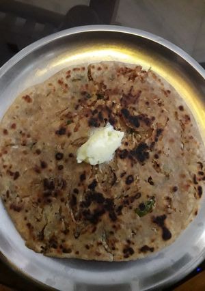 A picture of Mooli prantha with butter.