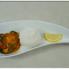 A picture of Basa fish fillet curry with parsley.