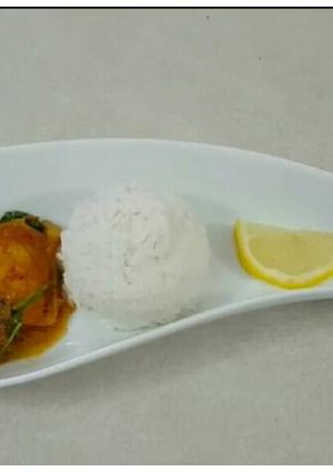 A picture of Basa fish fillet curry with parsley.
