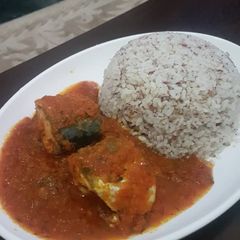 A picture of Titus fish stew and ofada rice.
