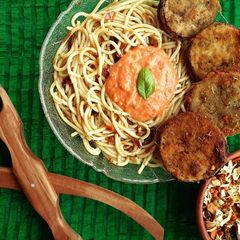 A picture of Parmigiana with herbed spaghetti.