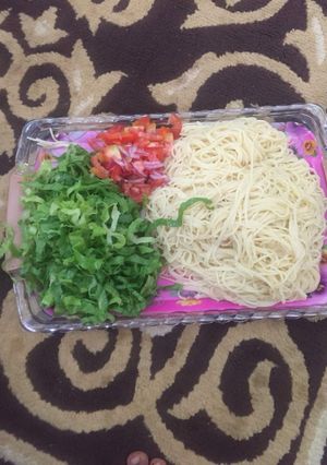 A picture of White spaghetti with salad.