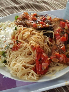 A picture of Pasta with pepper sauce and coleslaw.