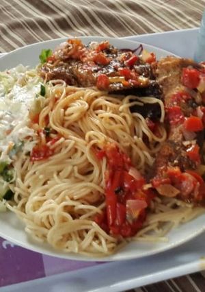 A picture of Pasta with pepper sauce and coleslaw.