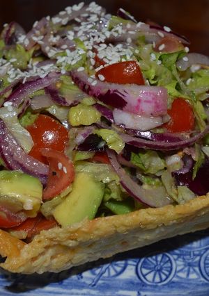 Una foto de Ensalada de palta en canastilla de parmesano