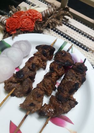 A picture of Seekh kabab on gas stove.