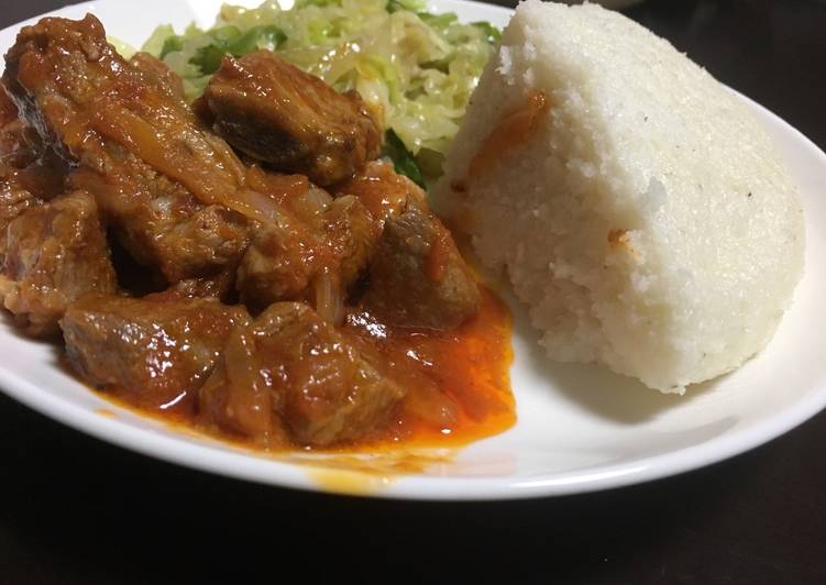 Ugali served with cabbage and beef wet fry