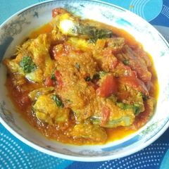 A picture of Macher tortori(fish in tomato gravy).