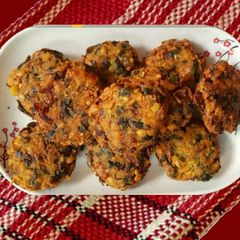 A picture of Multigrain fritters (vada) with fenugreek (methi)  and drumstick leaves.