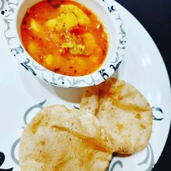 A picture of Puri and aloo bhaji.