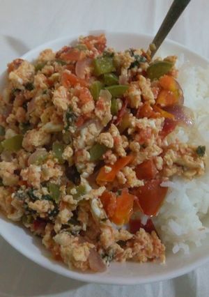 A picture of Scrambled eggs served with rice.