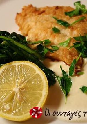 A picture of Fried cod-fish served with a garlic dip.