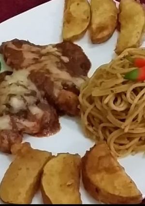 A picture of Cheesy Chicken with spaghetti & potato wedges.
