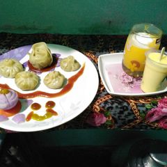 A picture of Momos with mango shake,vanilla icecream.