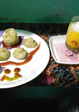A picture of Momos with mango shake,vanilla icecream.