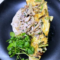 A picture of Asparagus omelette with a mushroom cream sauce.