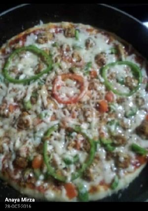 A picture of Pizza on stove.