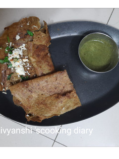 A picture of Paneer cheese stuffed Green moong dal chilla.