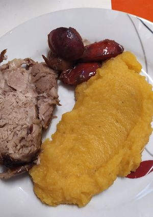 A picture of Pork Shoulder with Mustard, Spiced Plums, and Orange Sweet Potato Mash.