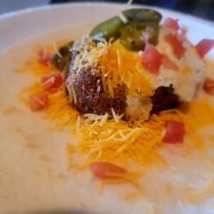 A picture of Mexi-tucky Burrito (Chorizo, Corned Beef Hash, Eggs etc).