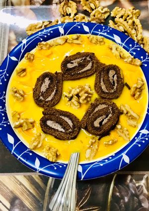 A picture of Swiss roll mangoes custard loaded with walnuts.