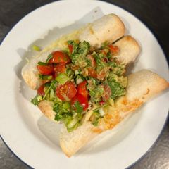 A picture of Beef enchiladas with salsa and guacamole.