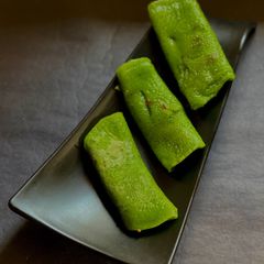 A picture of Patishapta with a spinach purée.