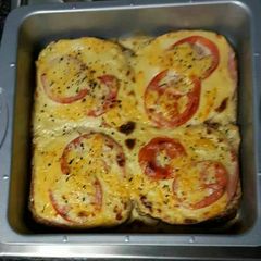 A picture of Cheese and tomato baked toast.
