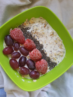 A picture of Overnight Oats Topped With Strawberries and Grapes.